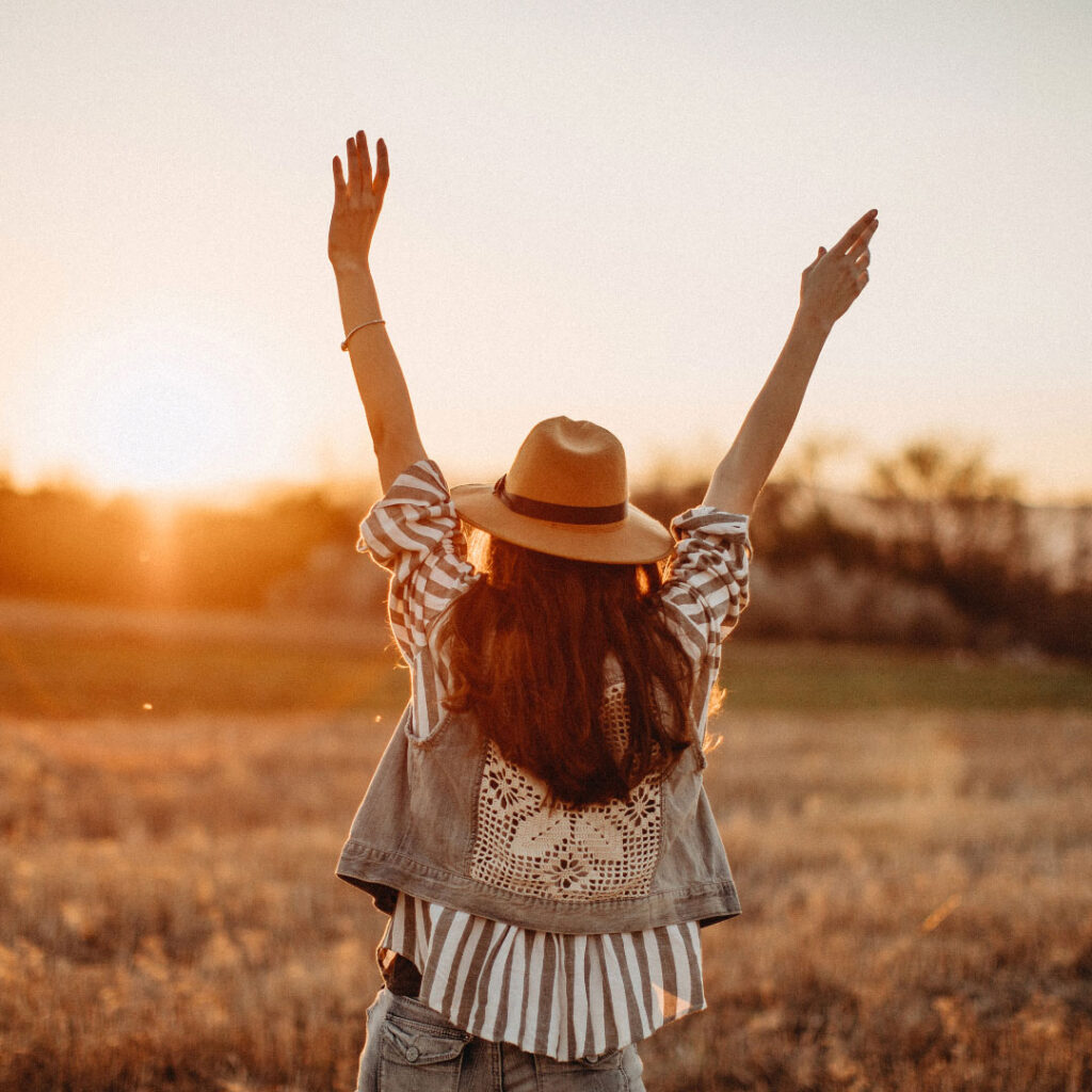 woman with arms up in joy